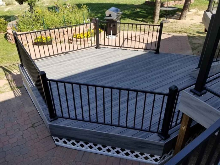 A deck with a black railing.