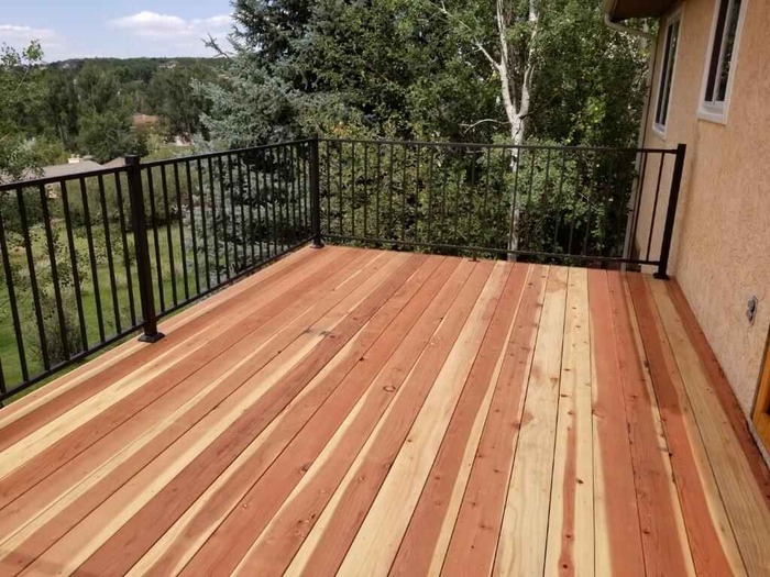 wood deck with black iron railing